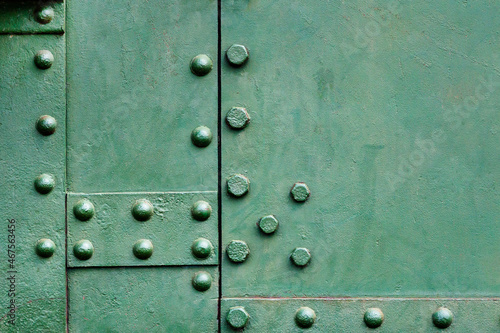 Texture of green metal with rivets. Background of a metal surface. Copyspace