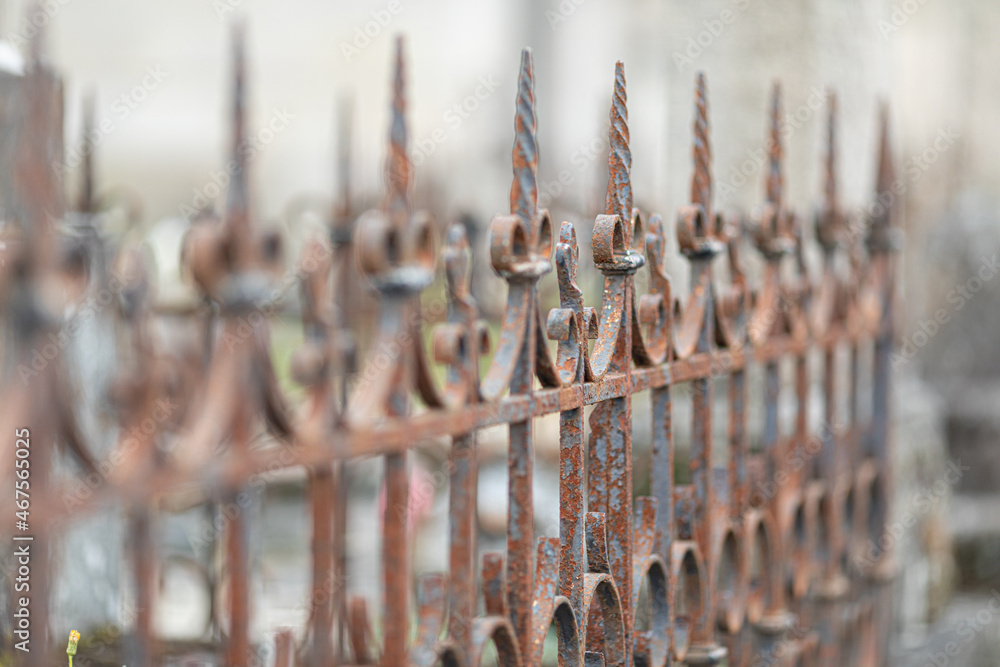 Selective focus shot of an old rusty metal fence