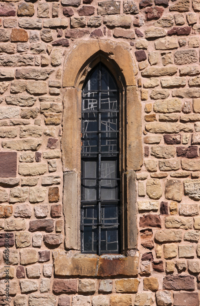 Simple pointed ogive arch of a narrow gothic window at St Peter and Paul church in Echternach, Luxembourg