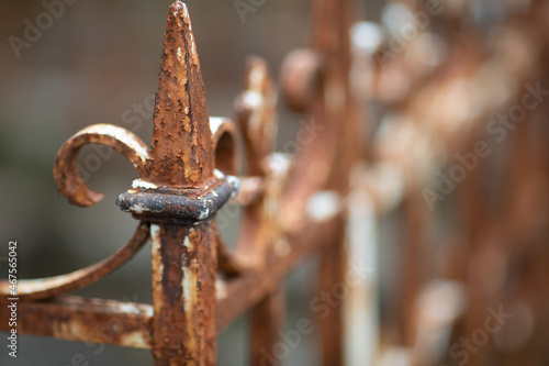 Selective focus shot of an old rusty metal fence photo