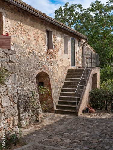 Fototapeta Naklejka Na Ścianę i Meble -  Ancient Farmhouse and Rural Dwelling with outdoor Stairs in the Medieval Village of  Monteriggioni, Siena - Italy