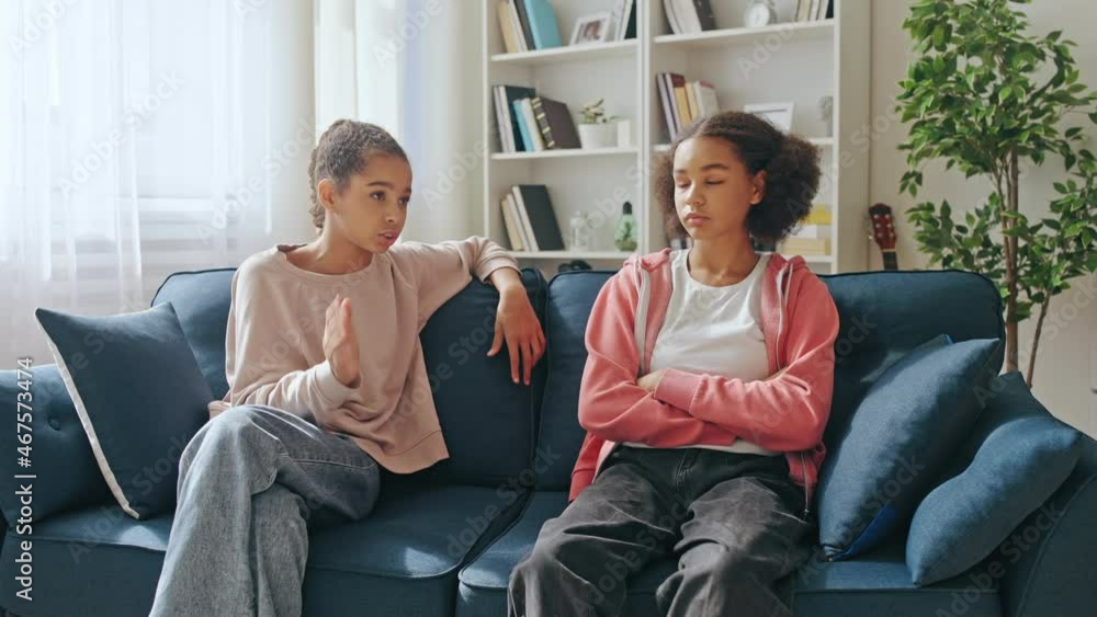 Sad black girl talking to female friend at home, discussing problem, support Sad black girl talking to female friend at home, discussing problem, support