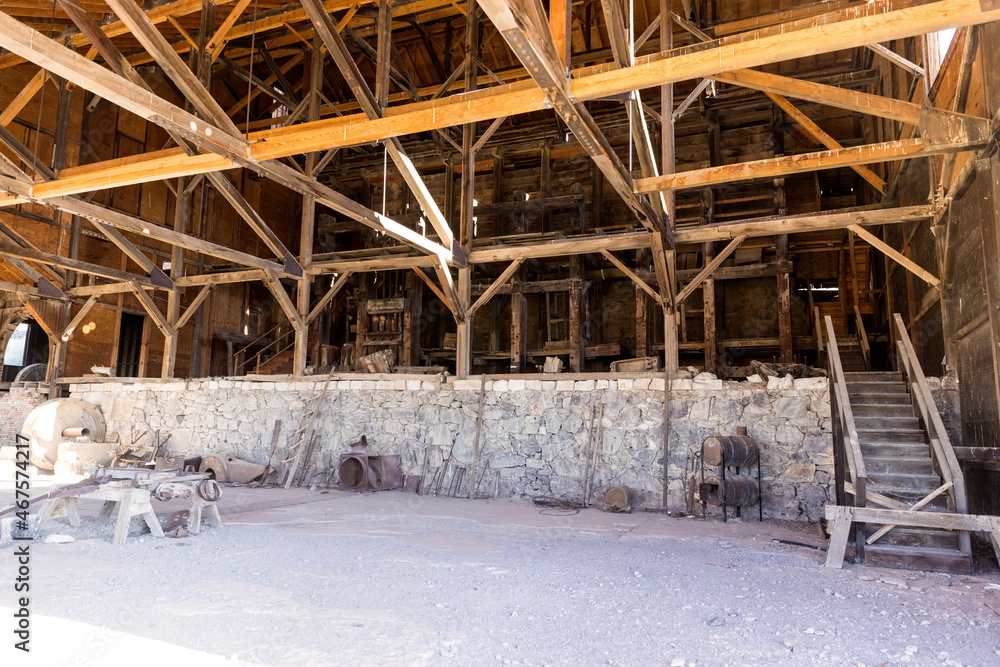 Huge wooden building with concrete structures and ore processing wheels Huge wooden building with concrete structures and ore processing wheels