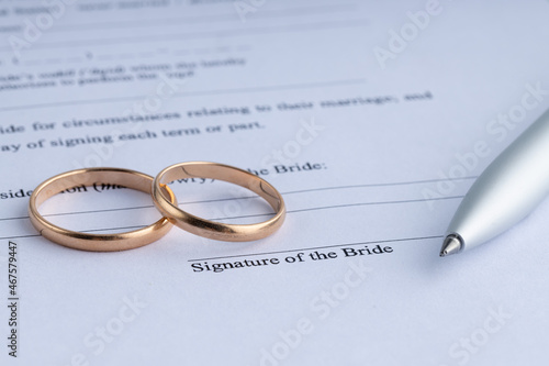 marriage contract form of prenuptial agreement with a pair of wedding rings photo