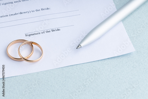 marriage contract form of prenuptial agreement with a pair of wedding rings photo