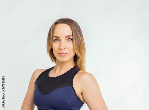 Blonde sporty muscular woman portrait isolated against white background
