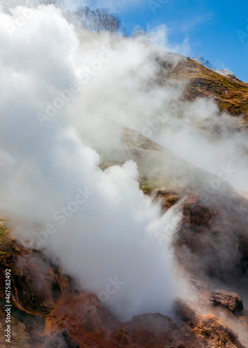Boiling water and steam gush from geyser in zone of volcanic activity.