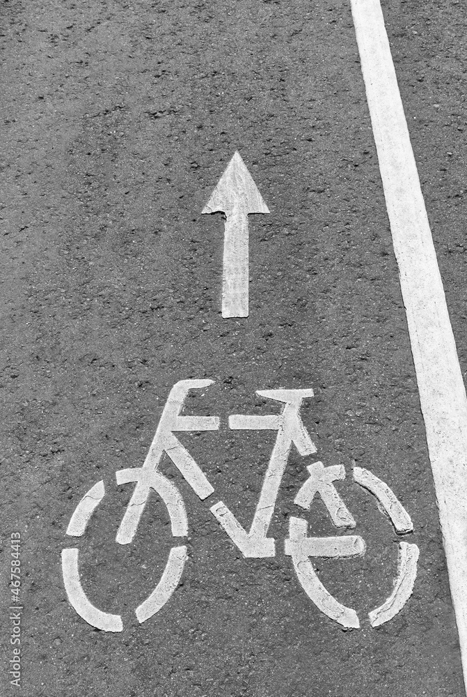 Bicycle sign painted in paint on the asphalt of the bike path in the park Bicycle sign painted in paint on the asphalt of the bike path in the park