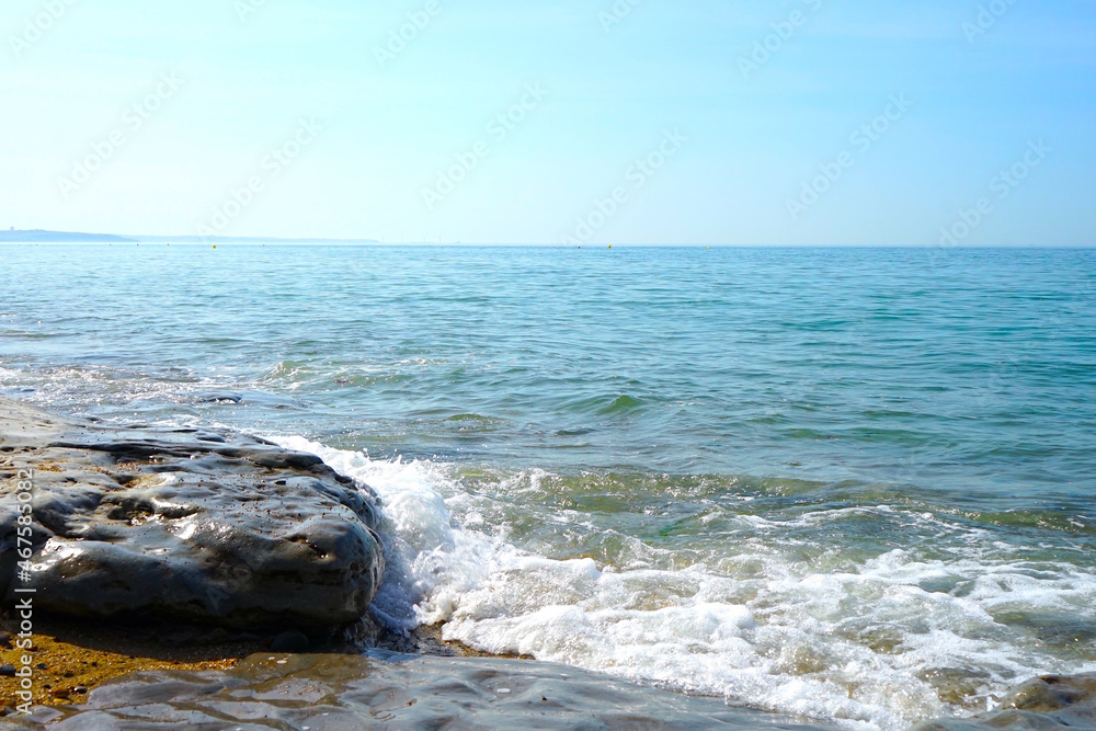 small waves of the ocean collide with rocks on the coast, Opal Coast small waves of the ocean collide with rocks on the coast, Opal Coast