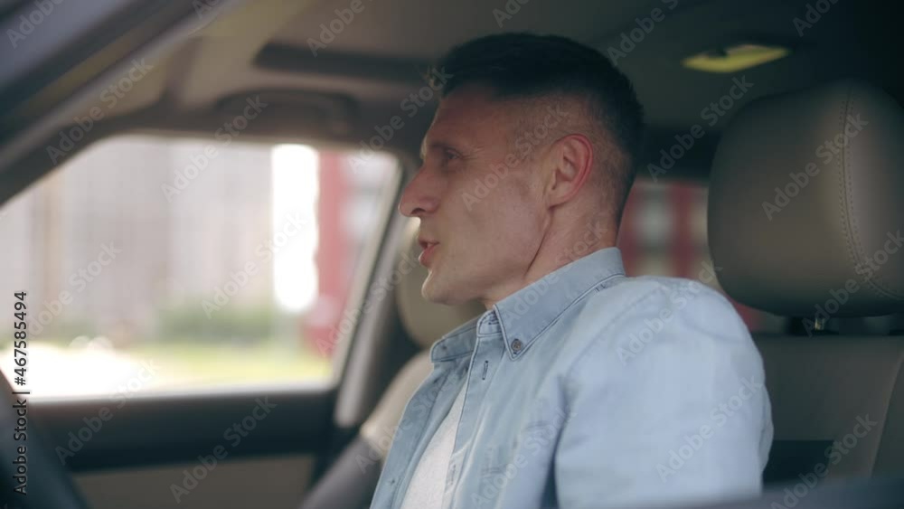 Handsome middle-aged man adjusting hairstyle in mirror, getting out from car Handsome middle-aged man adjusting hairstyle in mirror, getting out from car