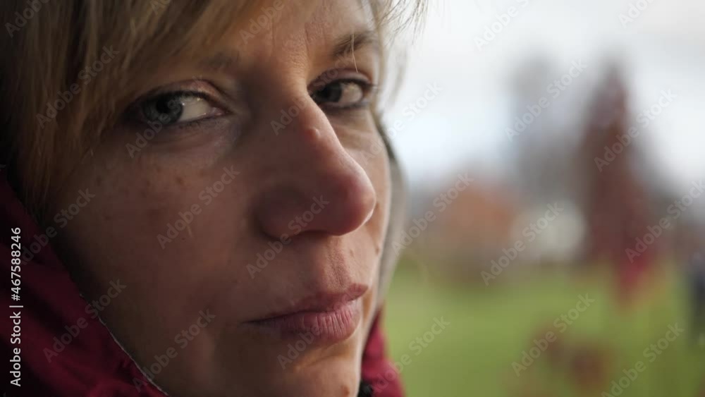 The woman at the window is warmly dressed. Cold house. The woman at the window is warmly dressed. Cold house.