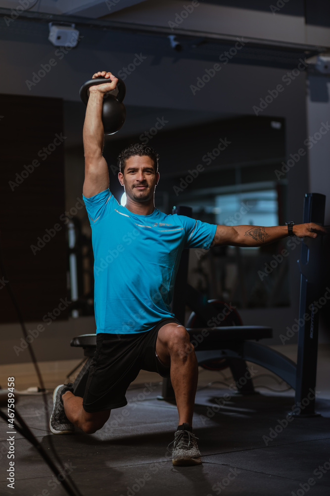 personal trainer performing a crossfit workout at gym personal trainer performing a crossfit workout at gym