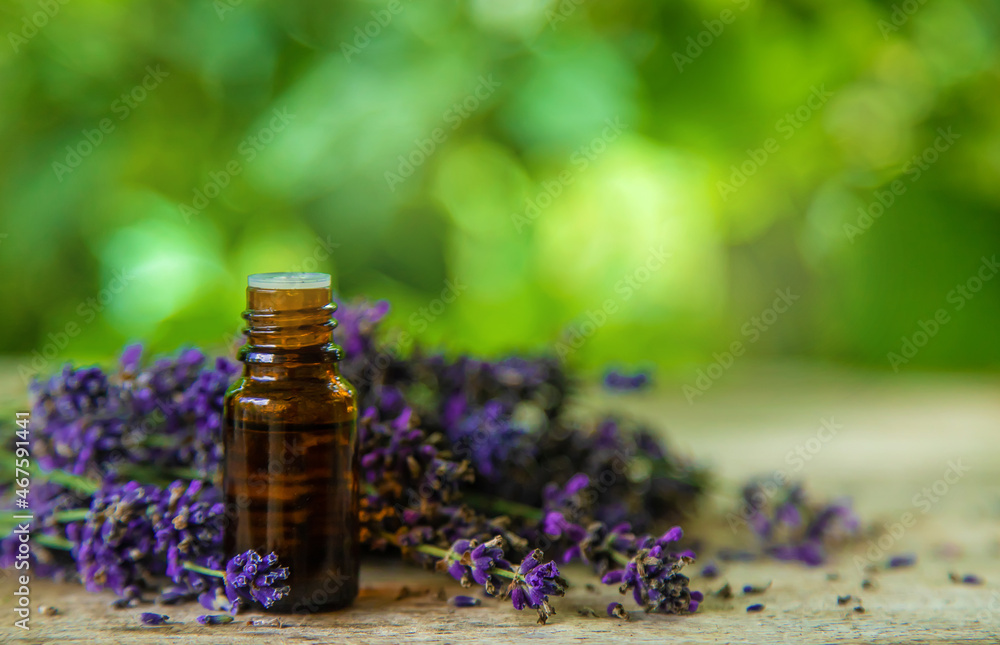 Lavender essential oil in a bottle. Selective focus. Lavender essential oil in a bottle. Selective focus.
