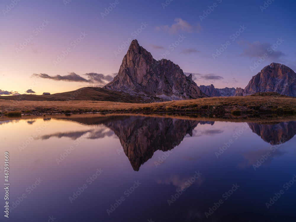 Fototapeta premium High mountains and reflection on the surface of the lake. Giau Pass, Dolomite Alps, Italy. Landscape in the highlands during sunset. Photo in high resolution.