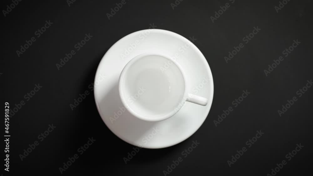 empty cup of coffee spinning on black background empty cup of coffee spinning on black background