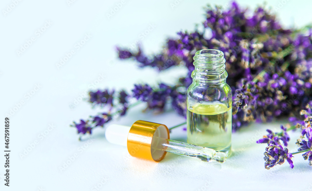 Lavender essential oil in a bottle. Selective focus. Lavender essential oil in a bottle. Selective focus.