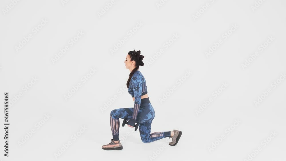 Young woman goes in for sports, fitness. Side view. fitness trainer in sportswear performs exercises to stay fit and healthy. White background. fitness and wellness concept.Slow motion
Young woman goes in for sports, fitness. Side view. fitness trainer in sportswear performs exercises to stay fit and healthy. White background. fitness and wellness concept.Slow motion