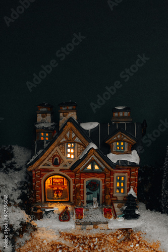 Famous New Year and Christmas toys of Lemax decorations with Christmas tree, snow and cozy vintage house. Luxury gifts and decorations for the winter holidays