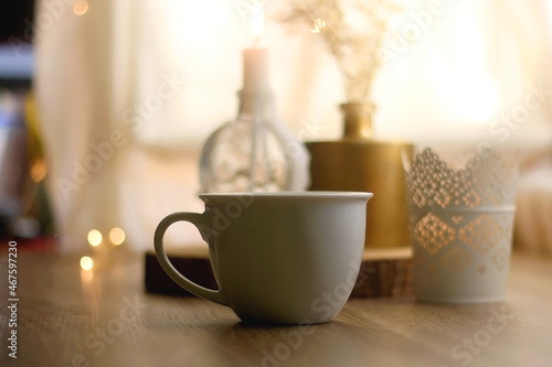 Wallpaper Mural Cup of warm drink, lit candles and flowers on a table. Hygge at home. Selective focus. Torontodigital.ca