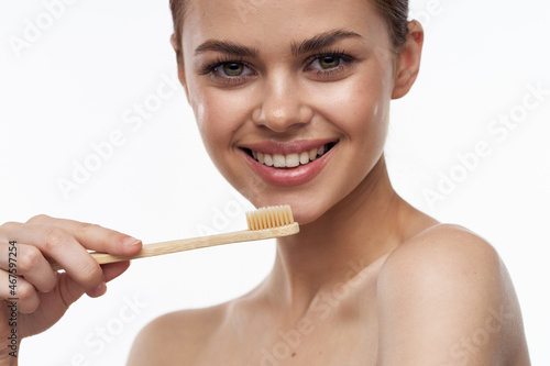 cheerful woman with bare shoulders toothbrushes hygiene oral care