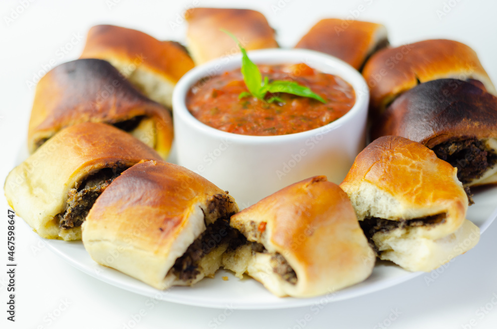 Patty's pies stuffed with minced meat, mushrooms and onion, served with sauce Patty's pies stuffed with minced meat, mushrooms and onion, served with sauce