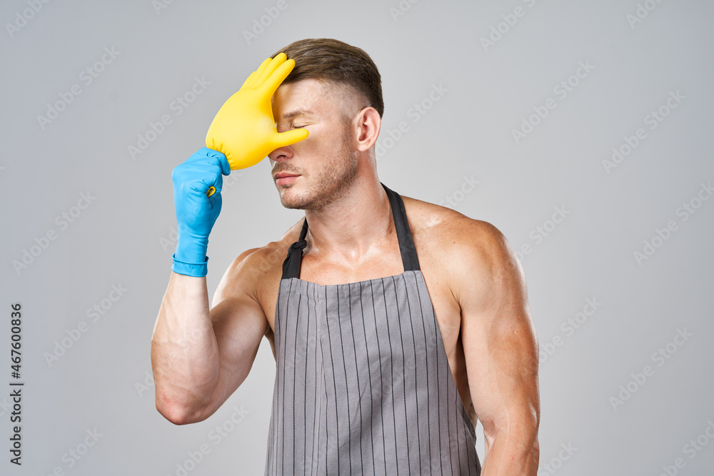 pumped up man in apron rubber gloves cleaning housework pumped up man in apron rubber gloves cleaning housework