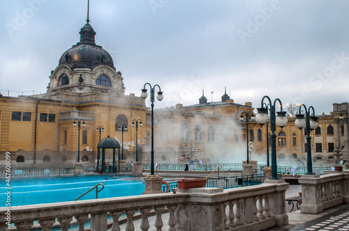 Old yellow thermal bath Széchenyi with hot steaming water in the middle of the city center of Budapest (Hungary) photo