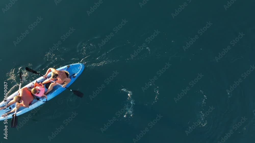 Top view of a family kayaking. Woman, man and children Top view of a family kayaking. Woman, man and children