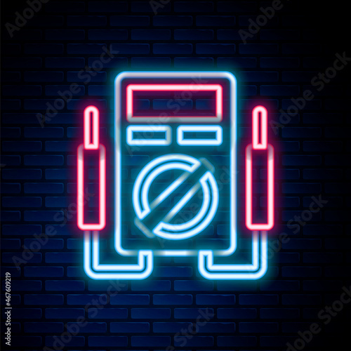 Glowing neon line Ampere meter, multimeter, voltmeter icon isolated on brick wall background. Instruments for measurement of electric current. Colorful outline concept. Vector