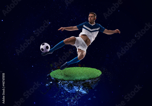 Football player kicks the soccer ball into space