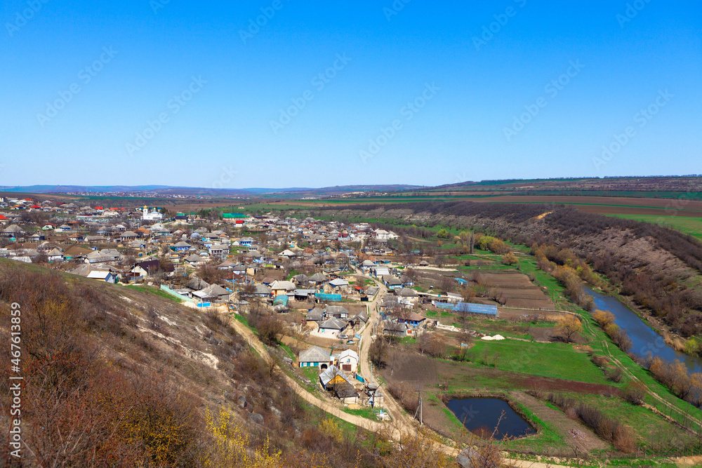 View of the village from the hill . Rustic settlement . Countryside riverside aerial panorama View of the village from the hill . Rustic settlement . Countryside riverside aerial panorama