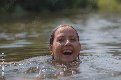Fototapeta Naklejka Na Ścianę i Meble -  Portrait of a beautiful girl in the river