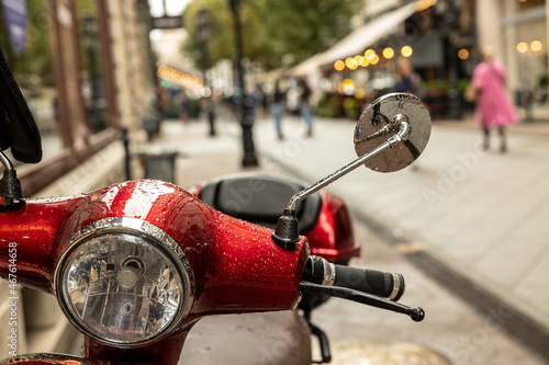 Red scooter parked in the street of Budapest