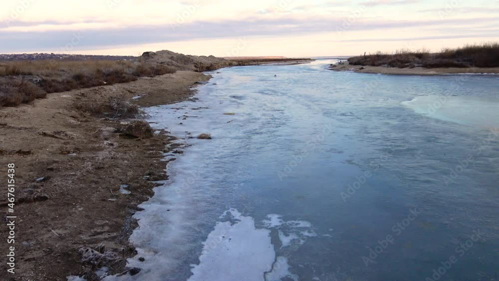 Ice on the surface of the water in the sea channel in the Tiligul Estuary, Black Sea Ice on the surface of the water in the sea channel in the Tiligul Estuary, Black Sea