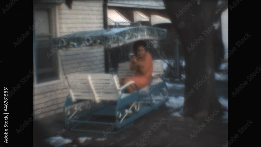 Chilly Outdoors 1966 - A woman sits outdoors in a gliding chair before becoming chilled and moving inside, in Wichita, Kansas 1966. Chilly Outdoors 1966 - A woman sits outdoors in a gliding chair before becoming chilled and moving inside, in Wichita, Kansas 1966.