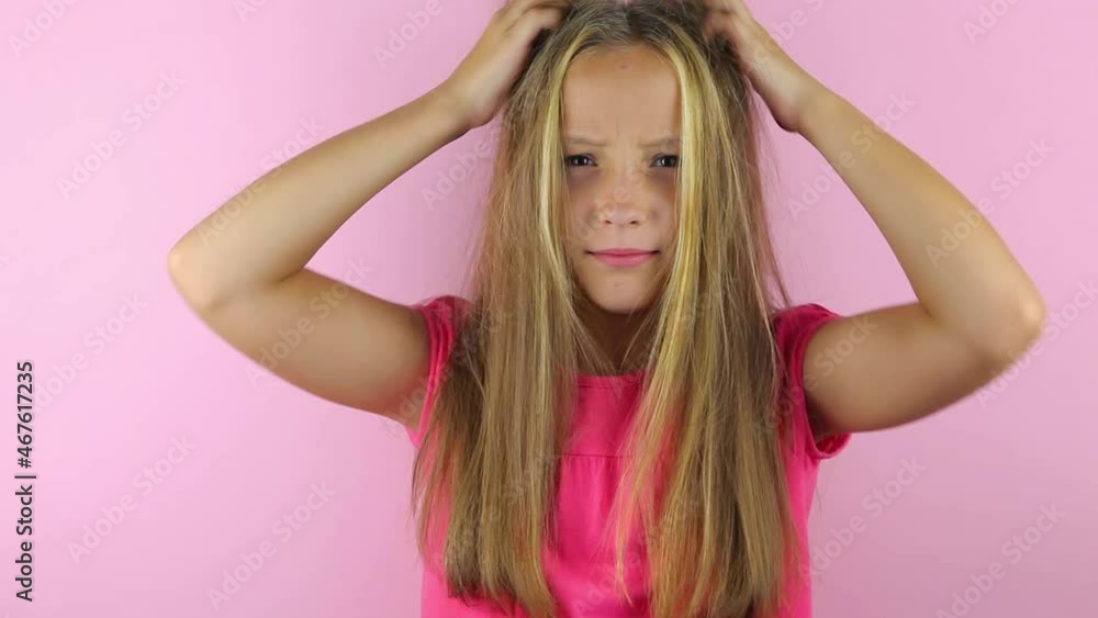 Girl scratches her head on a colored background Girl scratches her head on a colored background