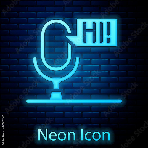 Glowing neon Microphone voice device icon isolated on brick wall background. Microphone interpreter and alphabet letters. Vector