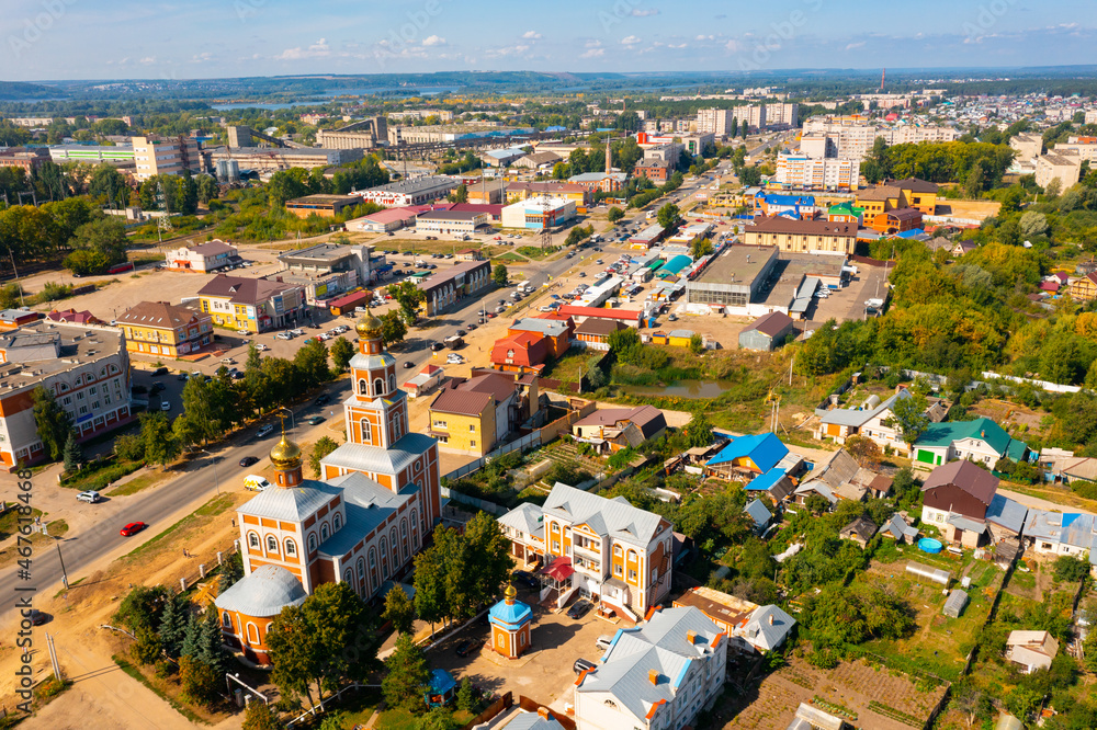 RUSSIA, VOLZHSK - AUGUST 23, 2021: Bird's eye view of Russian town Volzhsk. Aerial photo of buildings and streets.