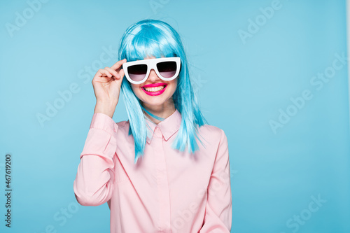 attractive woman in purple wig sunglasses model blue background