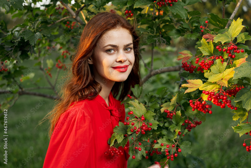 Naklejka premium cheerful woman eating berries outdoors fresh air
