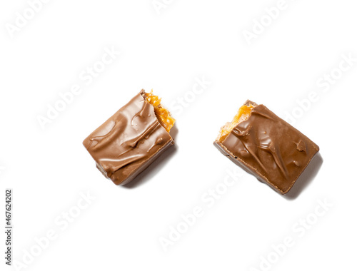 Broken chocolate bar on a white background. Slices of chocolate.