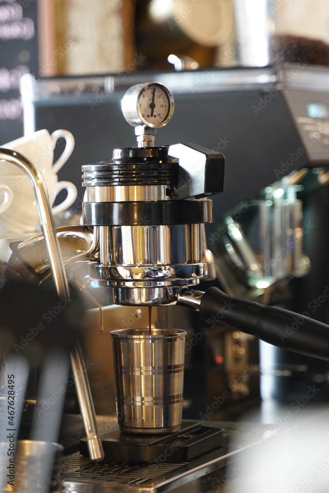 coffee espresso machine making the shot into stainless cup