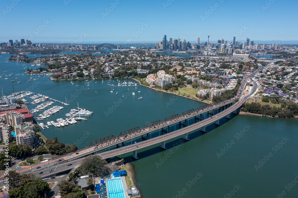 The Iron cove bridge over Iron Cove with the city of Sydney in the background.