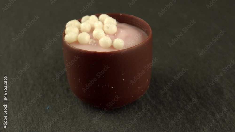 Multilayer candy with chocolate shell and various additives on the table. High content of carbohydrates, proteins and fats in products. Close-up. High quality. 4k footage. Multilayer candy with chocolate shell and various additives on the table. High content of carbohydrates, proteins and fats in products. Close-up. High quality. 4k footage.