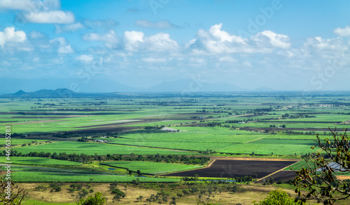 Panorama of Burdekin Queensland Australia farmland from above. Clouds cast shadows over the farmland, ocean in distance. photo