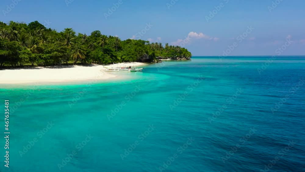 Seascape with a beautiful tropical island, aerial view. Beautiful white sand beach. Mahaba Island, Philippines. Blue sea with turquoise lagoons. Summer and travel vacation concept. Turquoise lagoon Seascape with a beautiful tropical island, aerial view. Beautiful white sand beach. Mahaba Island, Philippines. Blue sea with turquoise lagoons. Summer and travel vacation concept. Turquoise lagoon