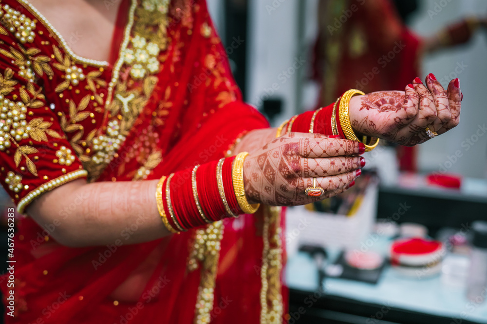 Indian bride's wearing her jewellery and bangles hands close up