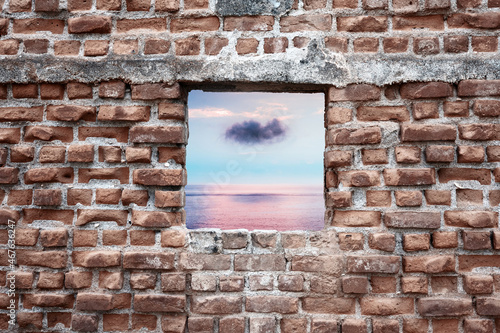 Ruined old brick wall window with sunset sky and sea view. Freedom  dream  imagination or isolation