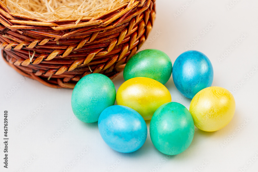 Easter eggs with basket on white background