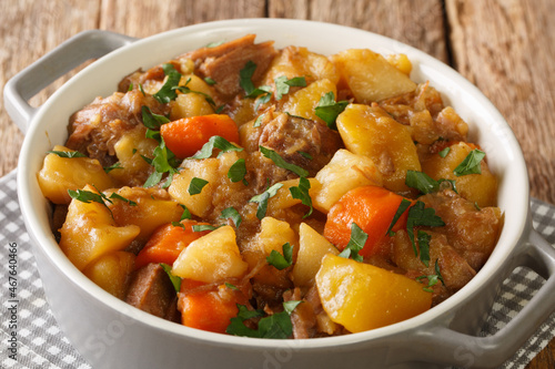 Stovies is a Scottish dish based on potatoes close up in the pot on the table. Horizontal